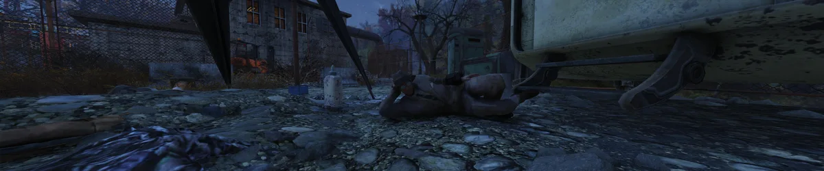 A character from Fallout 4 lies on a rocky ground under a large vehicle, wearing a hat and sunglasses, appearing relaxed or…