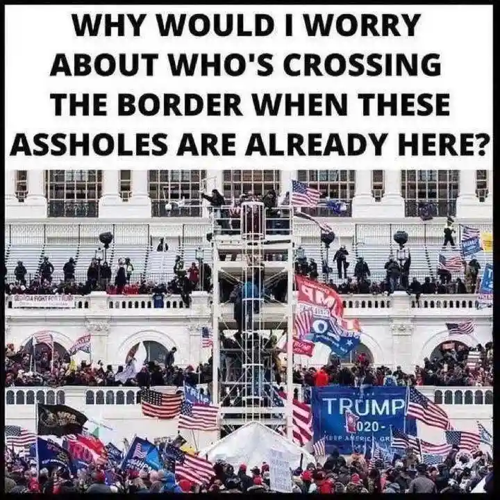 A large crowd of people, many holding American flags and 'TRUMP 2020' signs, gathers on and around the steps of a large…