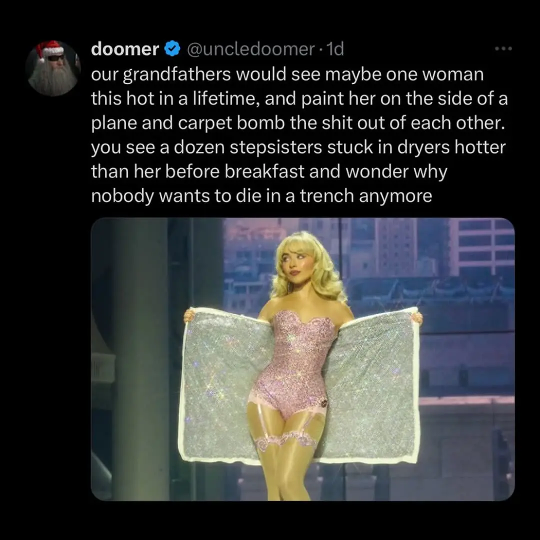 A blonde woman in a sparkly pink bodysuit and lace garter belt holds up two glittery silver blankets like wings. The…