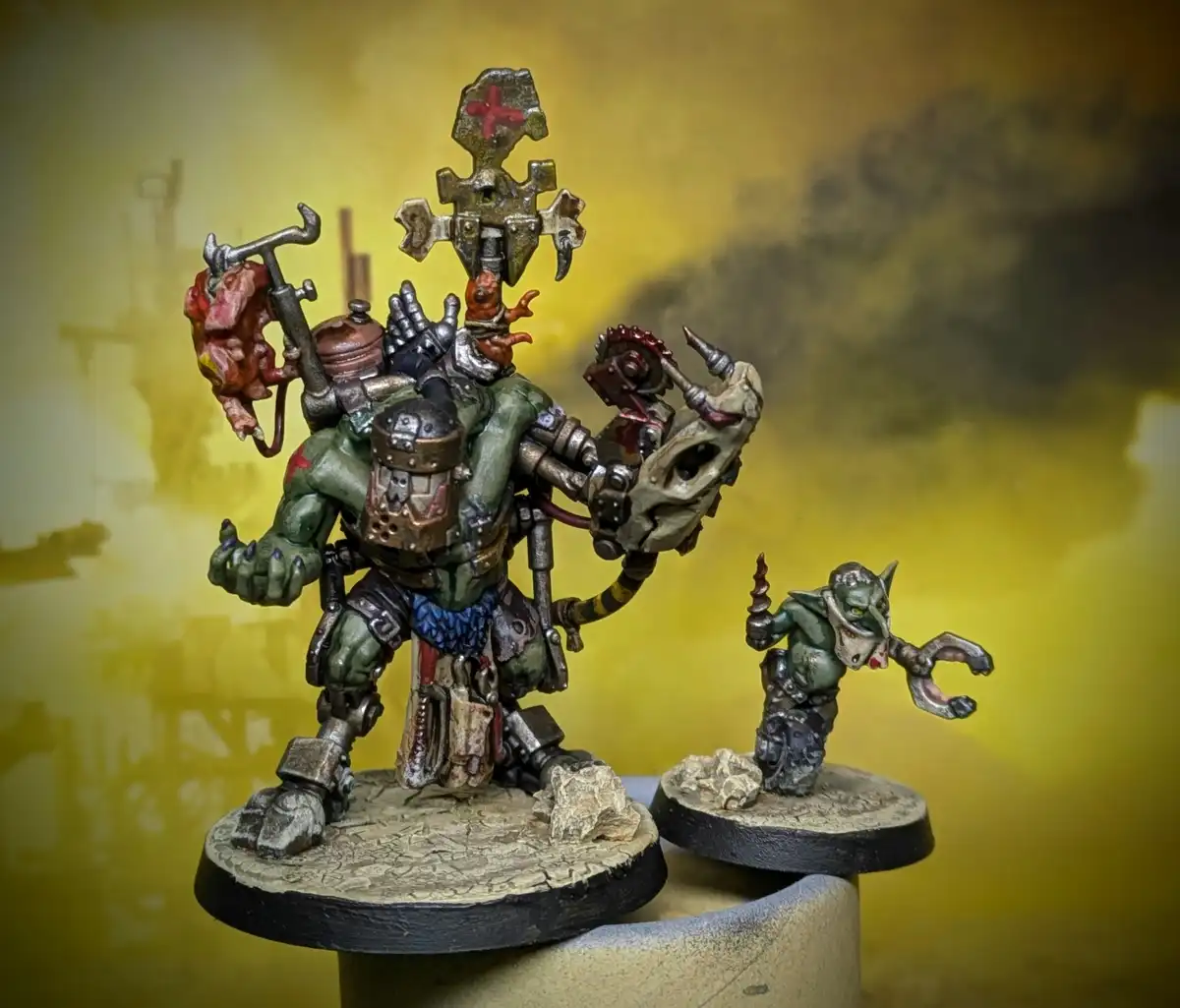 A heavily modified, grotesque green-skinned miniature figure, resembling a warlord or mutant, stands on a base holding a…