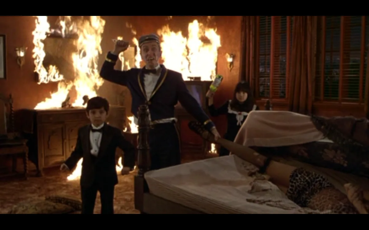a man in a uniform holds a bat while standing in a burning room, a child in a tuxedo stands nearby, and a woman in a sailor…