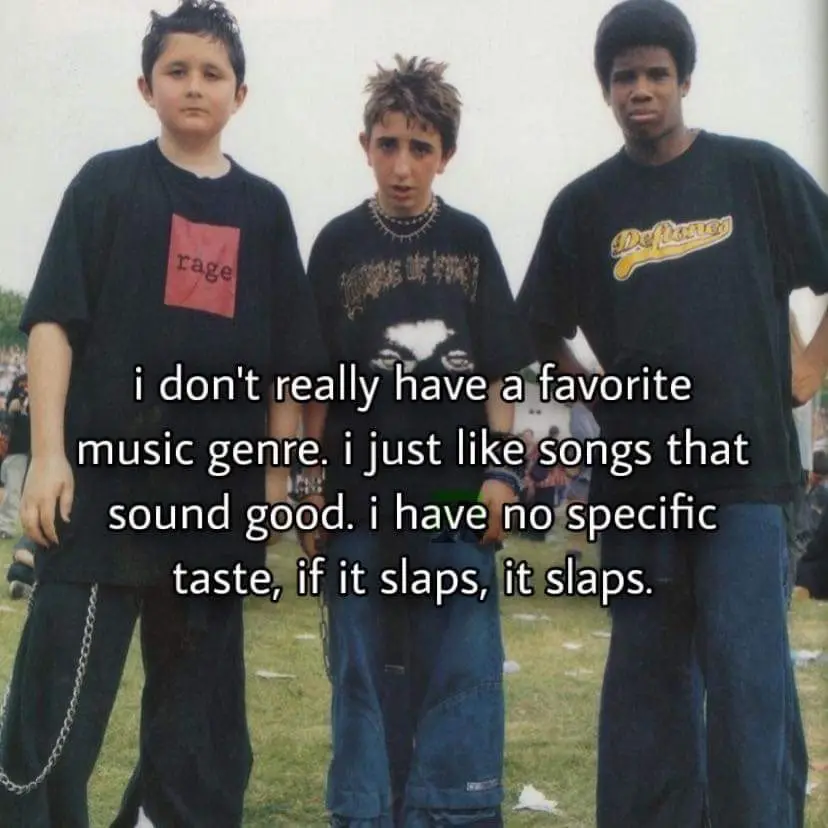 Three young boys in 90s-style clothing stand outdoors, looking serious. The central boy wears a graphic tee with a skull…