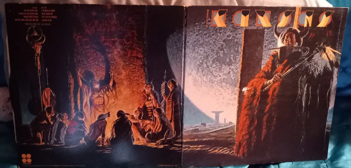 The image shows the open gatefold album cover of Kansas's 1974 album 'Monolith', featuring a dramatic, darkly lit…