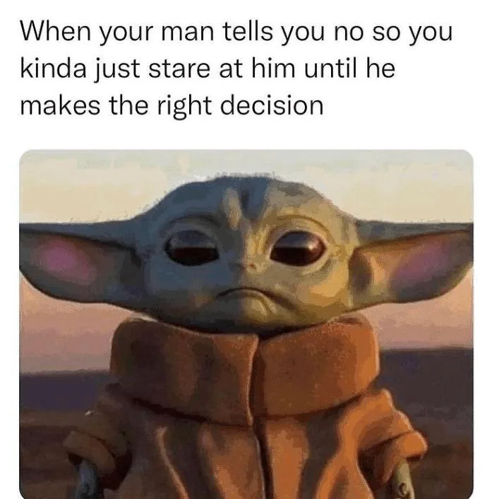 The image shows a close-up of Grogu (Baby Yoda) from Star Wars, wearing his signature brown robe, with a pouting, stubborn…