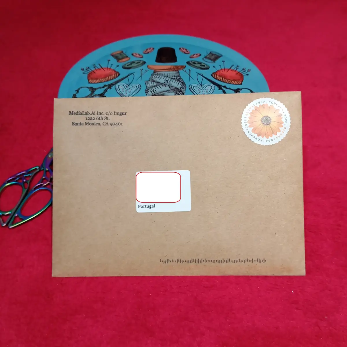 A brown envelope with a return address for 'MediaLab.Ai Inc. c/o Imgur' in Santa Monica, CA, and a 'Portugal' postage label…