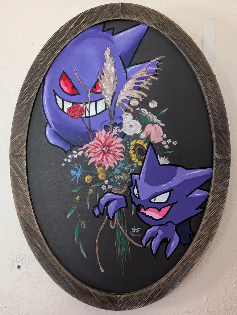 A framed painting shows two purple Gengar Pokémon from the Pokémon franchise. The smaller Gengar in the foreground holds a…