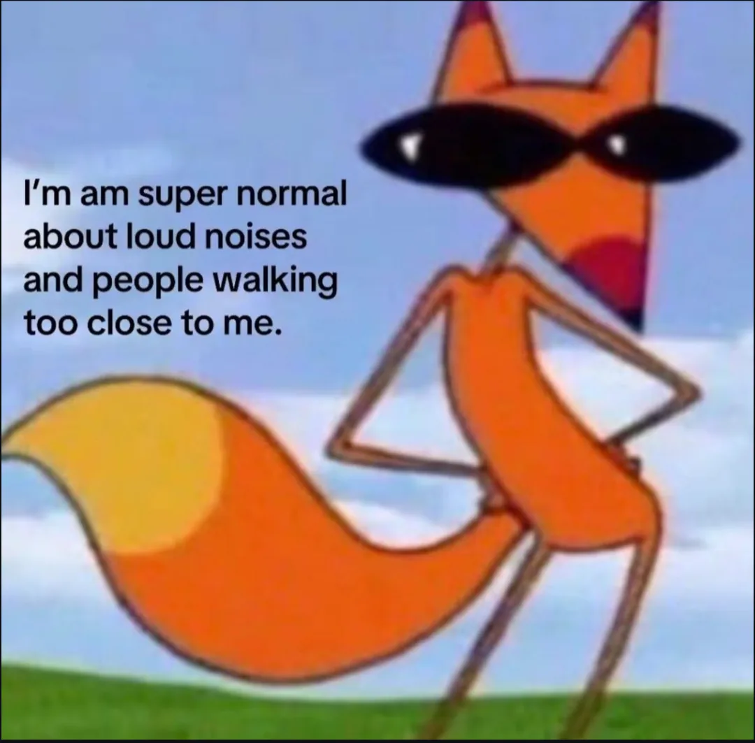 An orange cartoon fox wearing black sunglasses stands confidently with hands on hips against a blue sky and green grass…