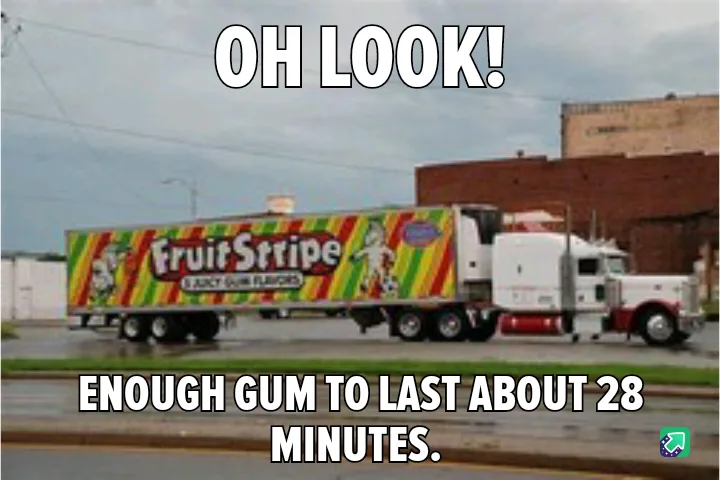 A white semi-truck with a colorful Fruit Stripe gum trailer is parked on a wet street. Large white text at the top reads 'OH…