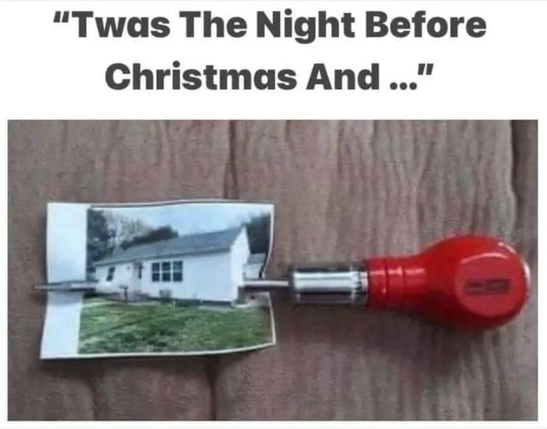 A printed photo of a white house with a grassy yard is being held in place by a red-handled screwdriver, as if the house is…