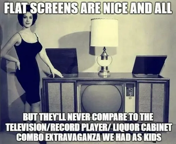 A vintage black-and-white photo shows a woman in a 1950s-style dress standing beside a large, bulky television set with two…