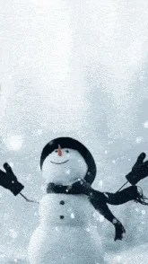 A snowman with a black hat, scarf, and gloves stands in a snowy landscape with trees in the background. The snowman has a…