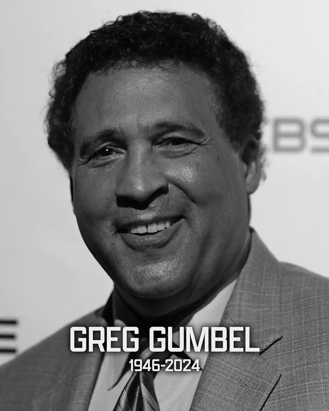 A black and white photo of a smiling man with curly hair wearing a suit and tie. Text overlaid at the bottom reads 'GREG…
