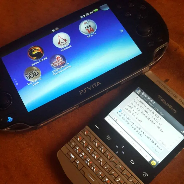 A photo shows a PS Vita with game icons like FIFA 14, Mortal Kombat, and The Walking Dead, next to a BlackBerry smartphone…