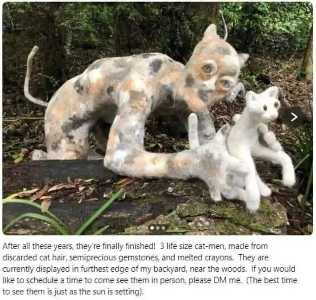 An outdoor photo shows three large, handmade cat sculptures made from textured materials resembling cat hair, gemstones, and…