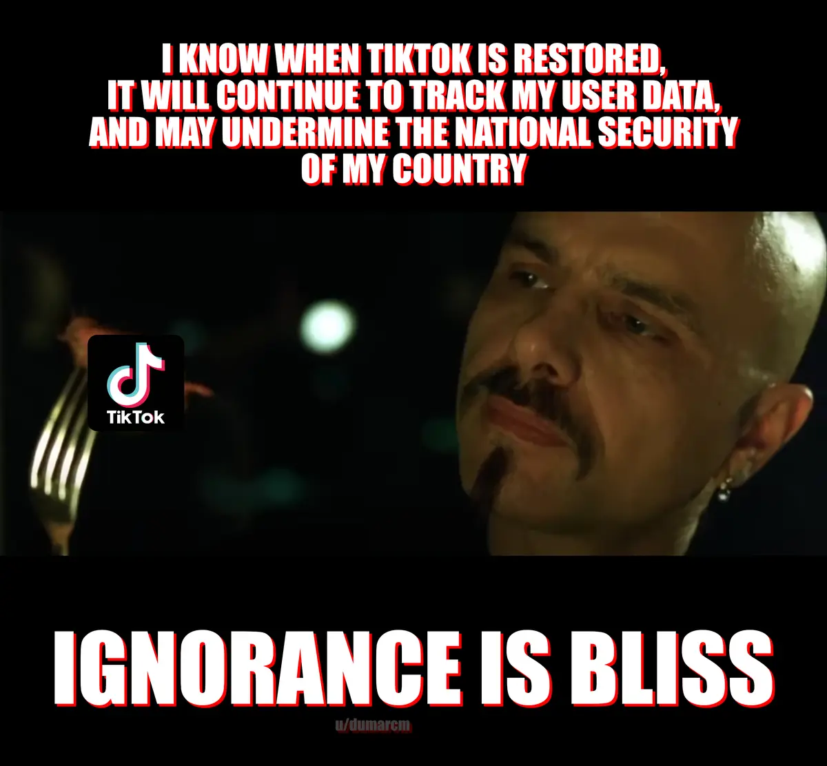 The image features a close-up of a bald man with a mustache and goatee, looking off to the side with a resigned expression…