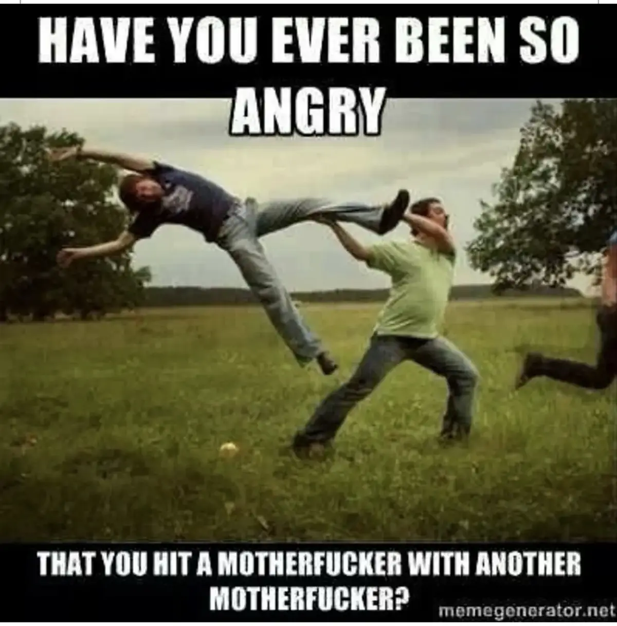 The image shows a man in a green shirt throwing another man in a blue shirt through the air in a grassy field. A third…