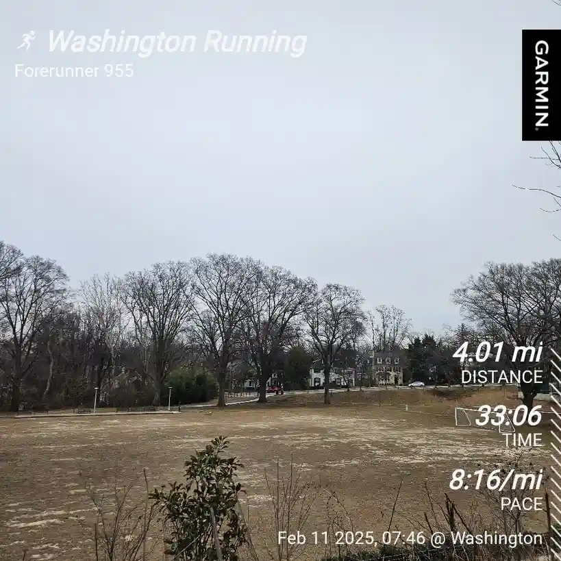 A screenshot of a Garmin Forerunner 955 running watch displaying a workout summary over a photo of a barren park on an…