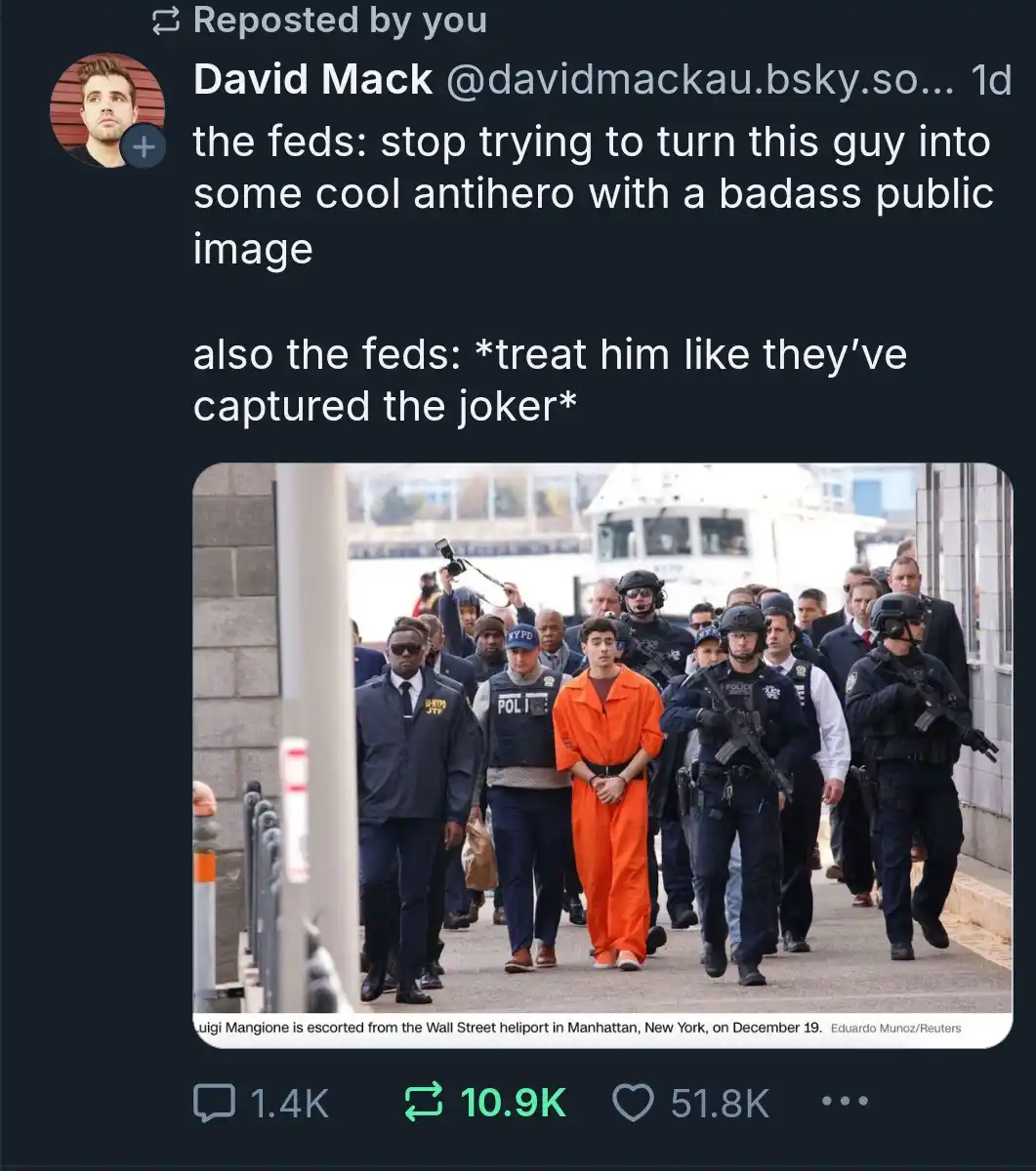 A photo shows Luigi Mangione, a young man in an orange prison jumpsuit, being escorted by numerous heavily armed NYPD…