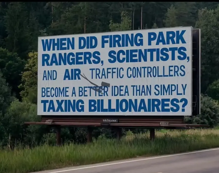 A large roadside billboard with blue text on a white background asks, 'WHEN DID FIRING PARK RANGERS, SCIENTISTS, AND AIR…