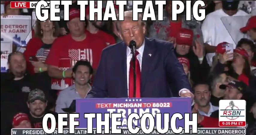 A man in a suit and red tie stands at a podium with 'TEXT MICHIGAN TO 88022 TRUMP' visible, surrounded by a crowd wearing…