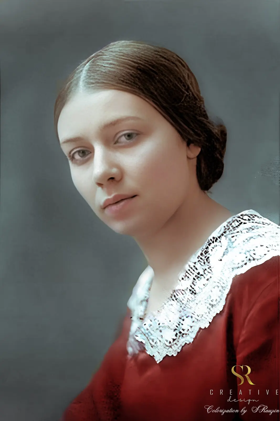 A colorized vintage portrait of a young woman with brown hair pulled back, wearing a red dress with a white lace collar…