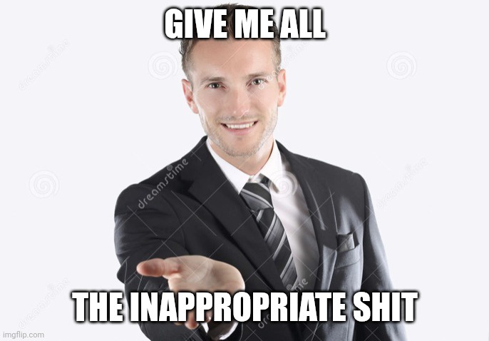 A man in a dark suit and striped tie smiles confidently while extending his hand forward against a plain white background…