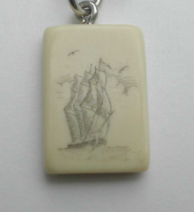 A close-up photo shows a rectangular, off-white pendant with a hand-drawn sketch of a sailing ship on it, complete with…