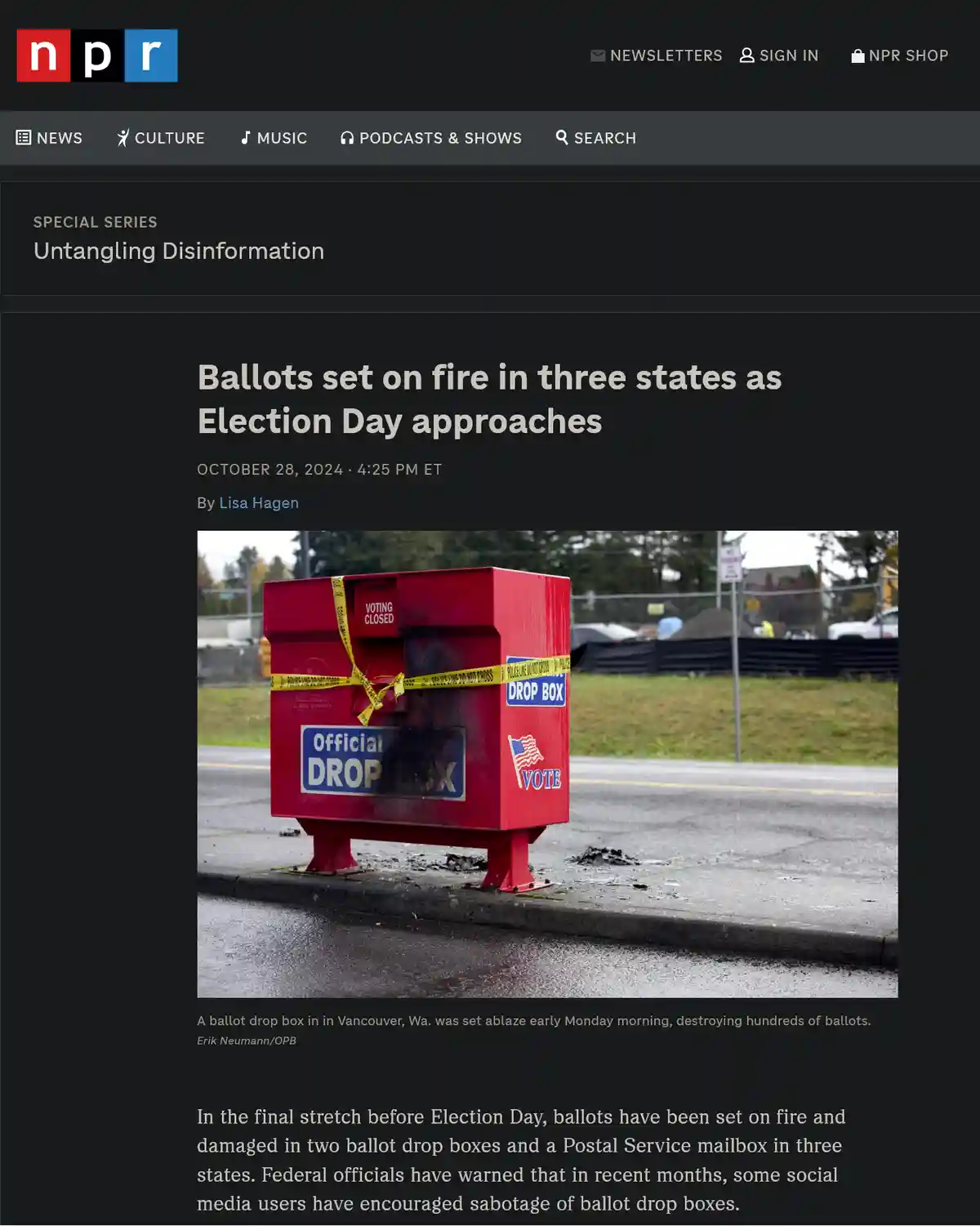 A red official ballot drop box is shown with visible burn damage and charred remains on the sidewalk, wrapped in yellow…