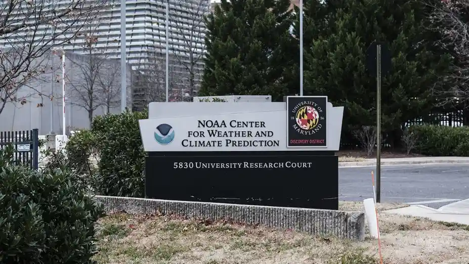 An outdoor photo of a large sign for the NOAA Center for Weather and Climate Prediction at the University of Maryland…