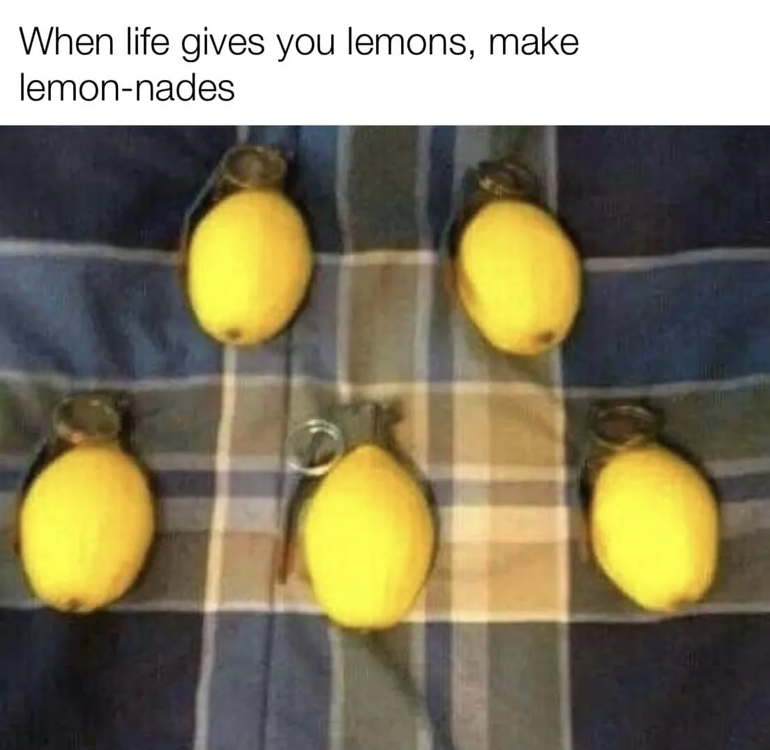 Five lemons are arranged on a blue and beige plaid fabric, each with a grenade-style pull ring attached to its stem. The top…