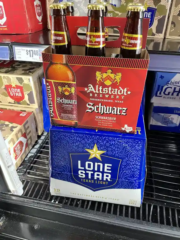 A six-pack of Altstadt Brewery Schwarz beer, labeled as 'Schwarzbier' and 'Premium German-Style Beer', is placed on top of a…