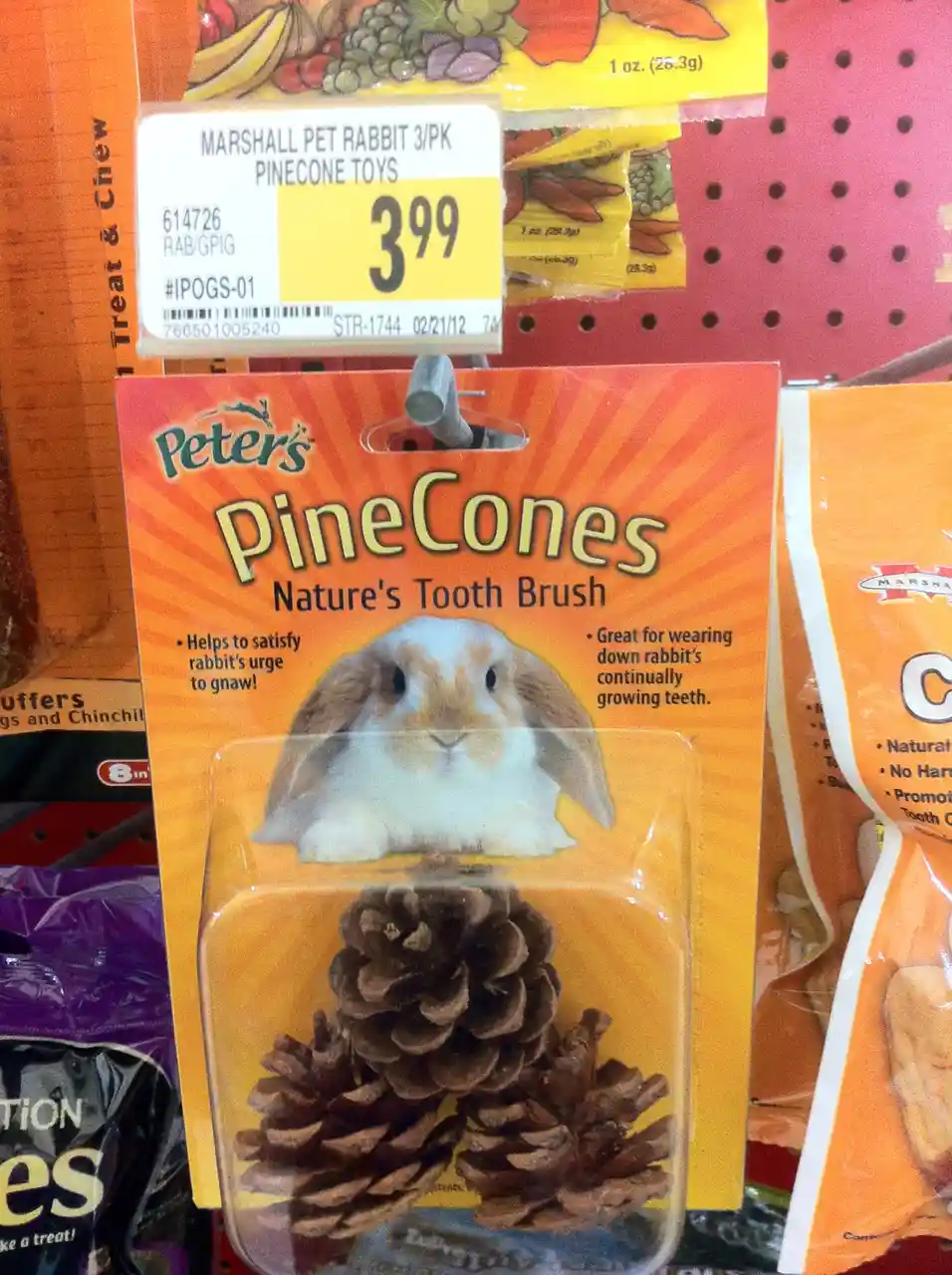 A package of Peters PineCones labeled as 'Nature's Tooth Brush' for rabbits, featuring a photo of a rabbit and three…