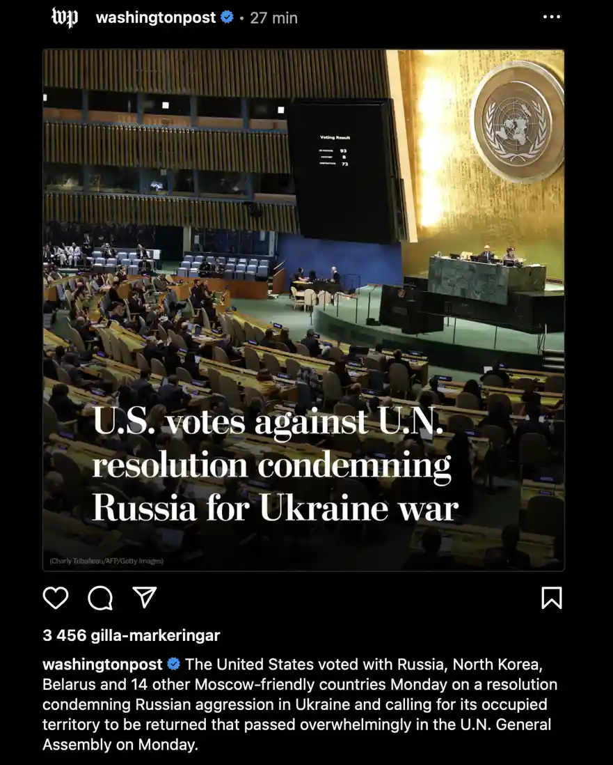 A photo of the United Nations General Assembly hall with delegates seated, a large screen showing a voting result of 93 in…