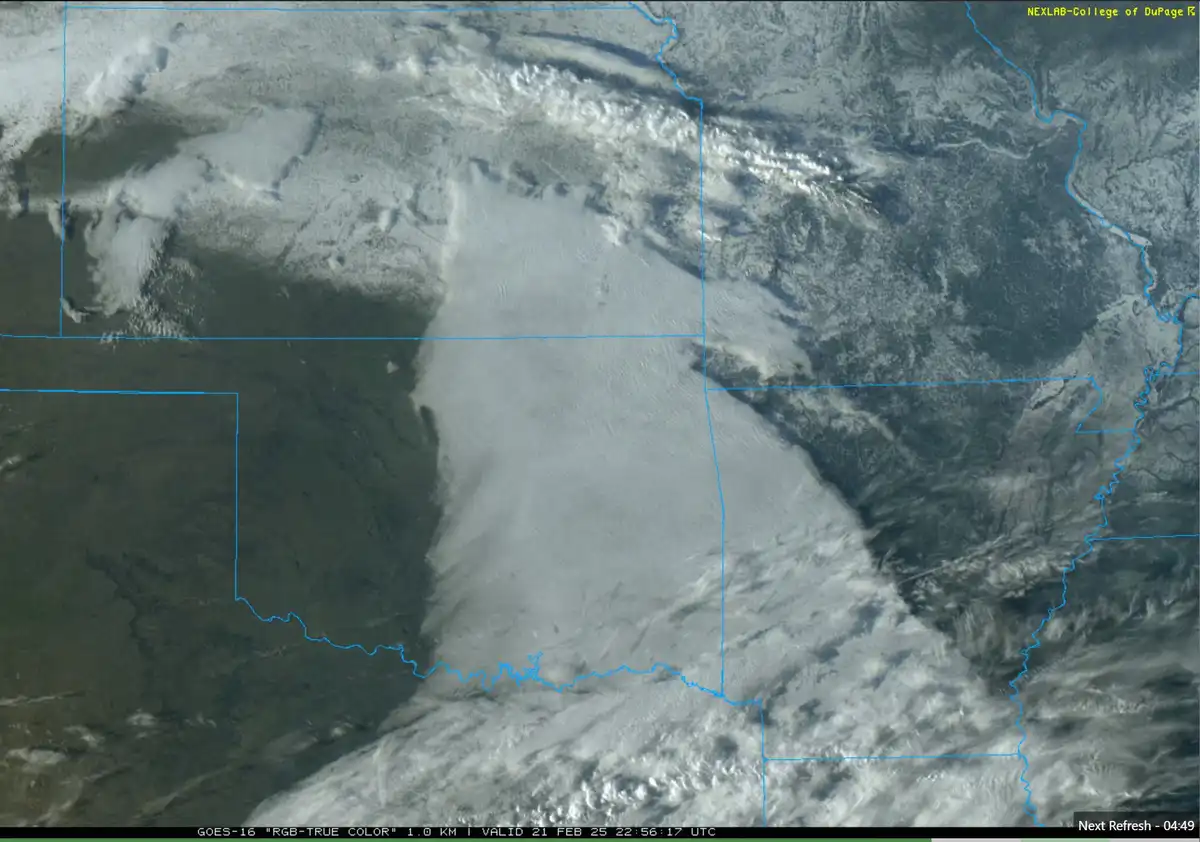 A satellite weather image from GOES-16 shows a large, distinct snow-covered area outlined in blue, resembling a giant…