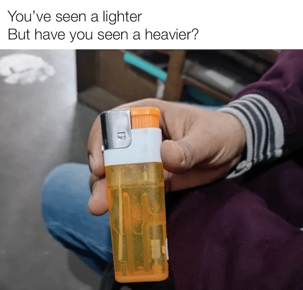 A person holds a translucent orange lighter filled with a thick, viscous yellow liquid, making it appear unusually heavy and…