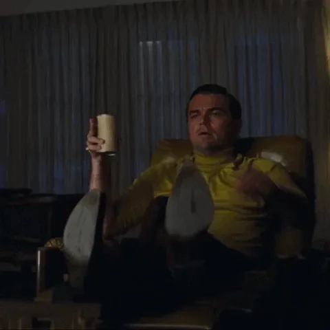 a six-panel grid shows a man in a yellow shirt sitting in a chair, holding a mug, and progressively pointing his finger…