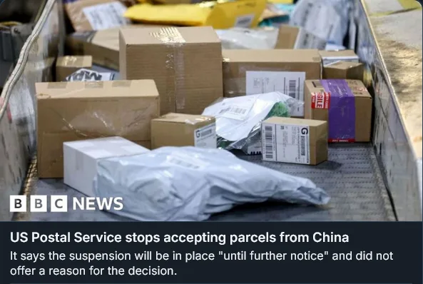 A conveyor belt in a postal facility is filled with various cardboard boxes and packages, including some with visible…