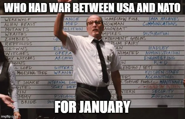 A man in a white shirt and tie stands in front of a whiteboard filled with handwritten movie monster and genre titles like…
