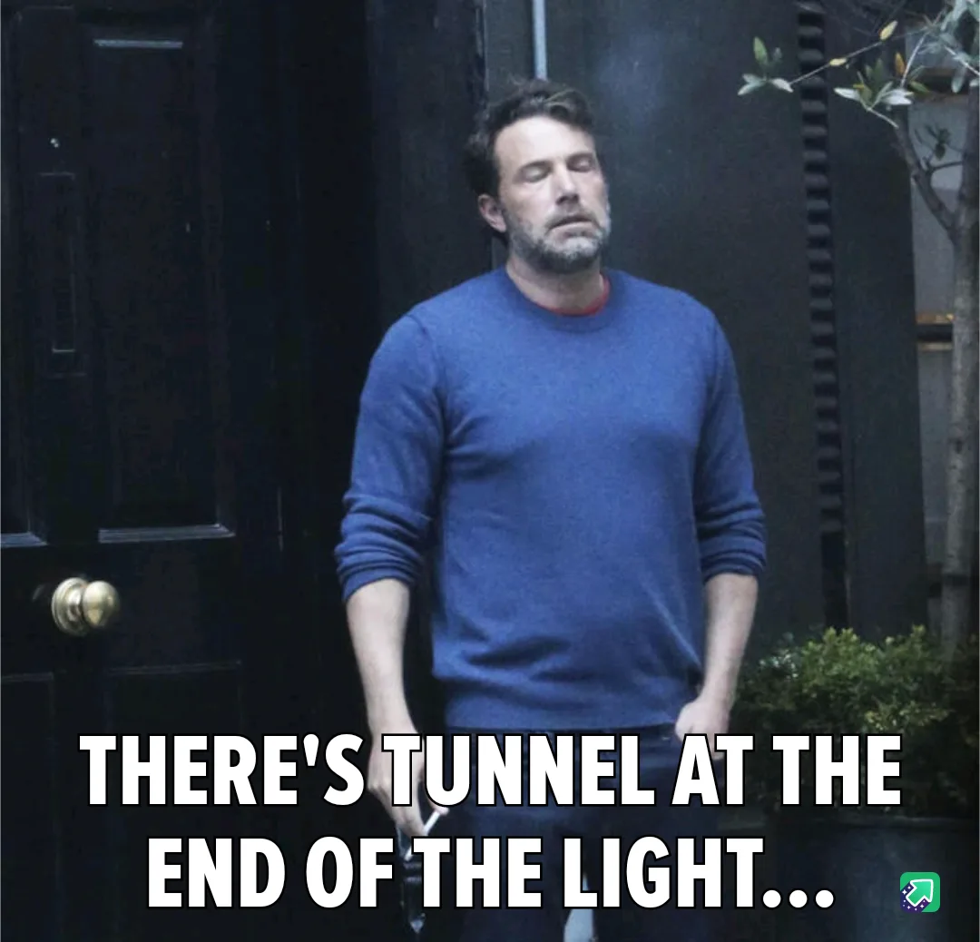 A man with a weary expression stands in front of a dark door, wearing a blue sweater. The overlaid text reads 'THERE'S…