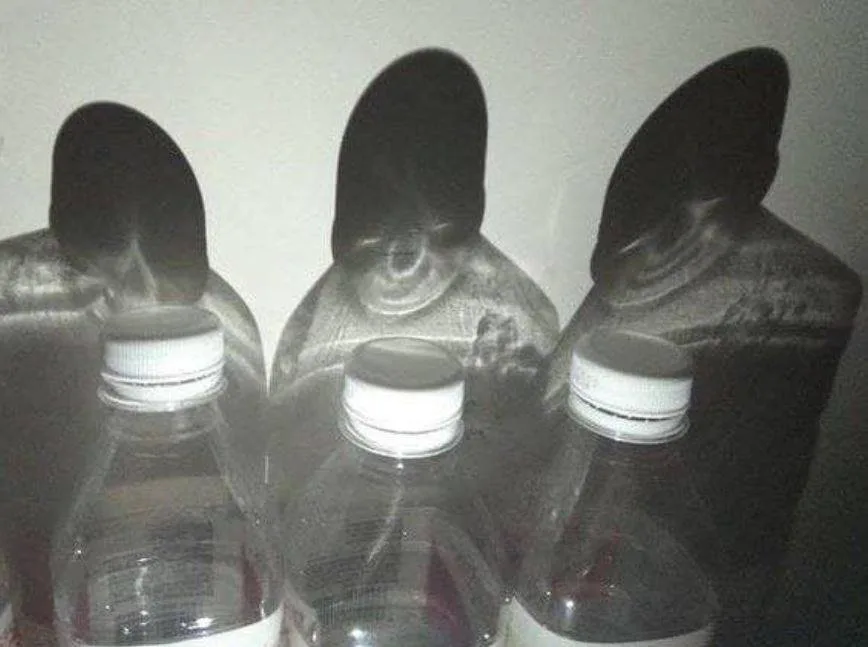 Eerie Shadows Cast by Water Bottles