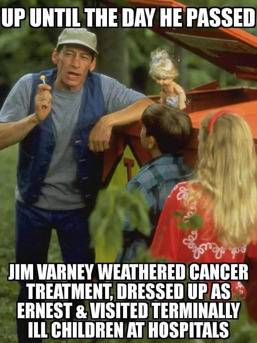 A still from the movie 'Ernest Goes to Camp' shows actor Jim Varney as Ernest, holding a lollipop and speaking to two…