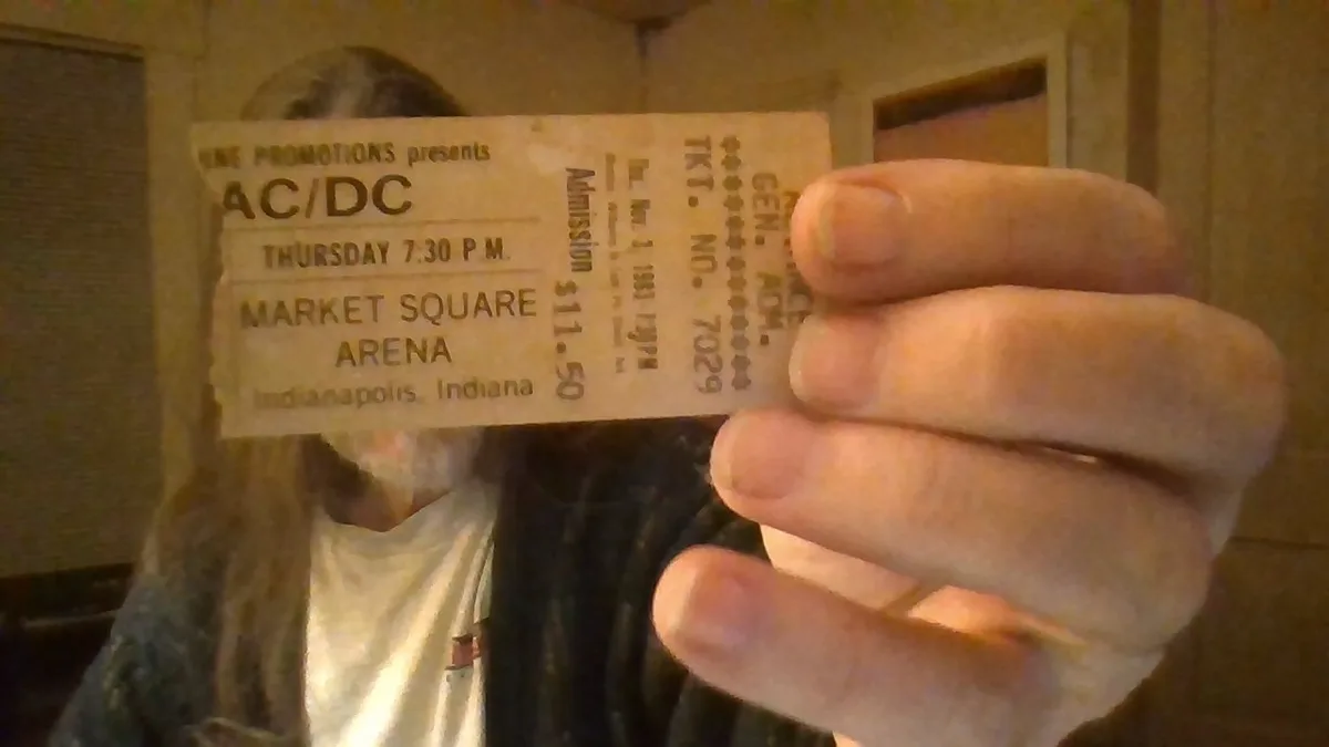 A person holds up a vintage AC/DC concert ticket from Thursday at 7:30 p.m. at Market Square Arena in Indianapolis, Indiana…