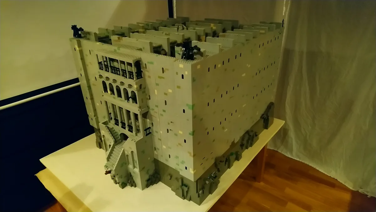 a large, intricate lego model of a multi-story building with detailed architecture, including arched windows, columns, and a…