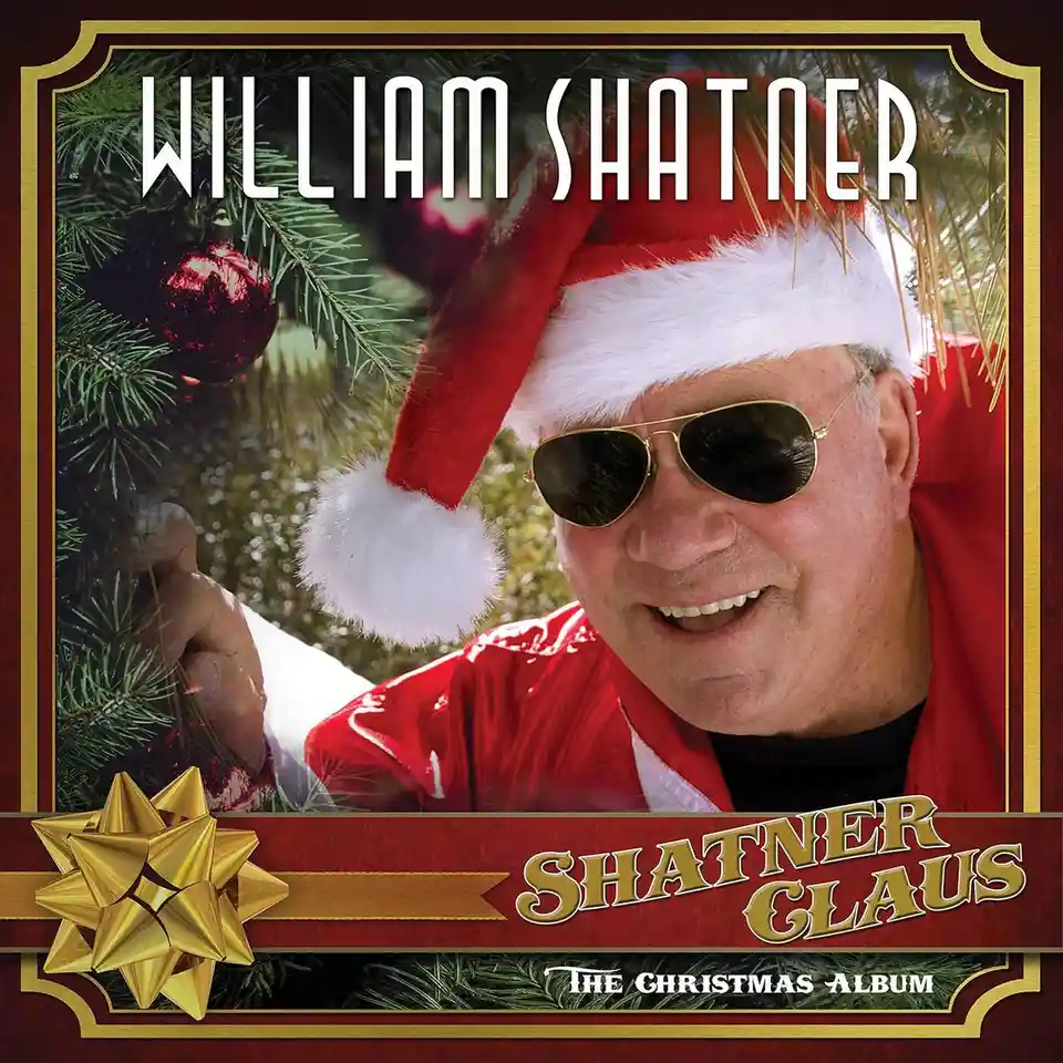 A man wearing a red Santa hat and sunglasses smiles while holding a Christmas tree branch. The image is styled like an album…