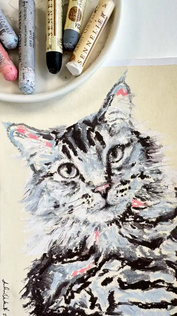 A close-up of a textured oil pastel drawing of a fluffy gray cat with wide, expressive eyes and pink inner ears, rendered…