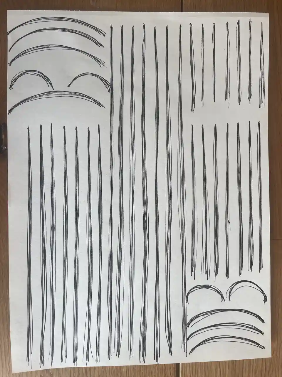 A hand-drawn image on white paper shows two cartoonish faces with exaggeratedly sad expressions, one at the top left and one…
