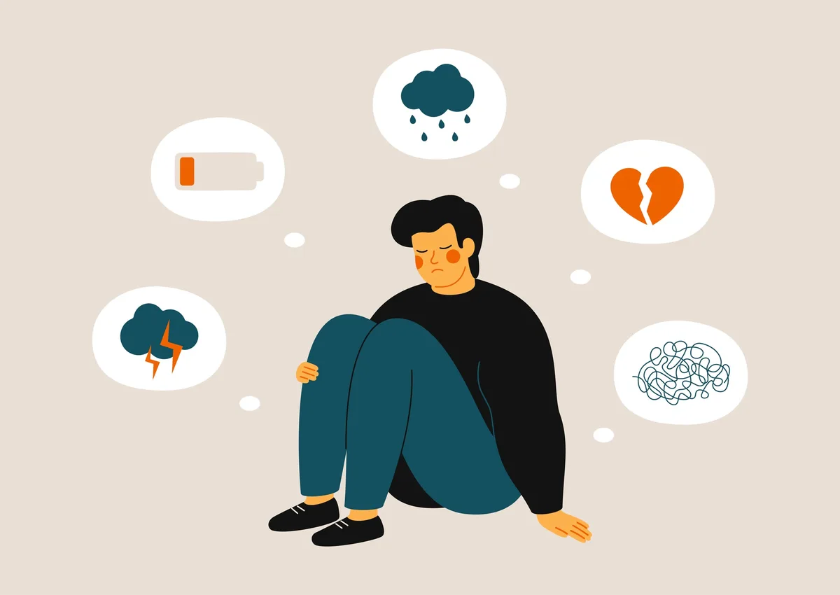 An illustrated person sits slumped on the floor looking sad, surrounded by thought bubbles showing a low battery, a rain…