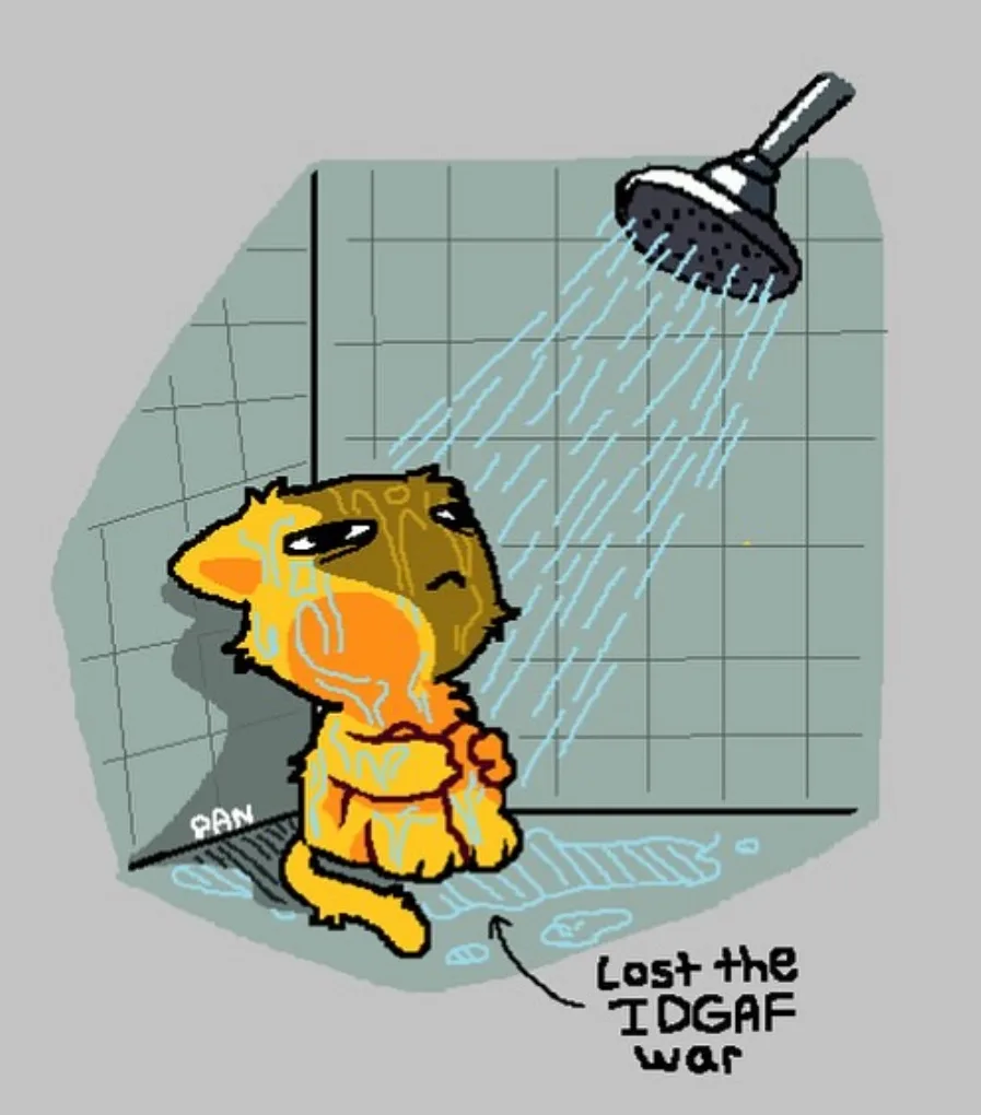 A cartoon cat sits defeated in a shower stall, water pouring down on it, with text below pointing to the cat that reads…