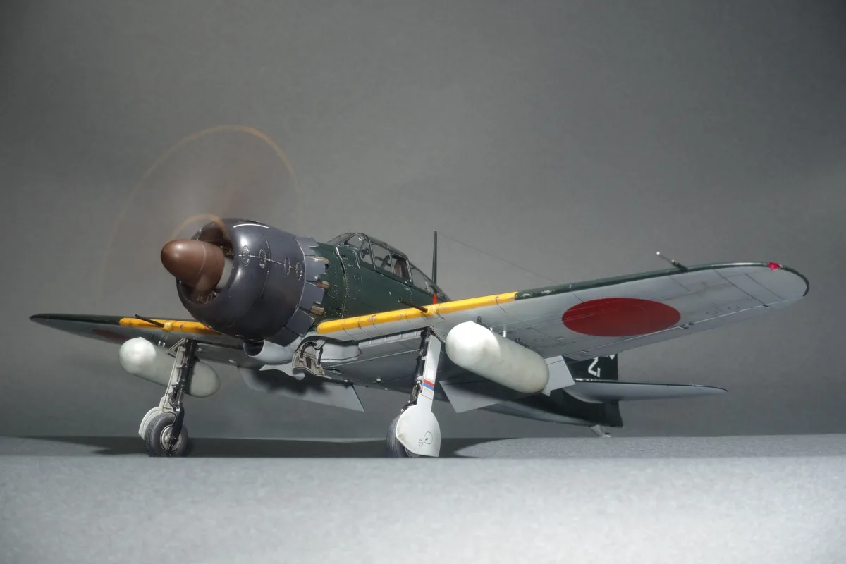 A highly detailed scale model of a Japanese World War II fighter plane, likely a Nakadžima Sakae-powered aircraft, is shown…