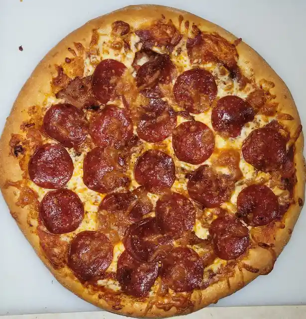 A top-down photo of a round pizza with a golden-brown crust, melted cheese, and numerous circular pepperoni slices. The text…